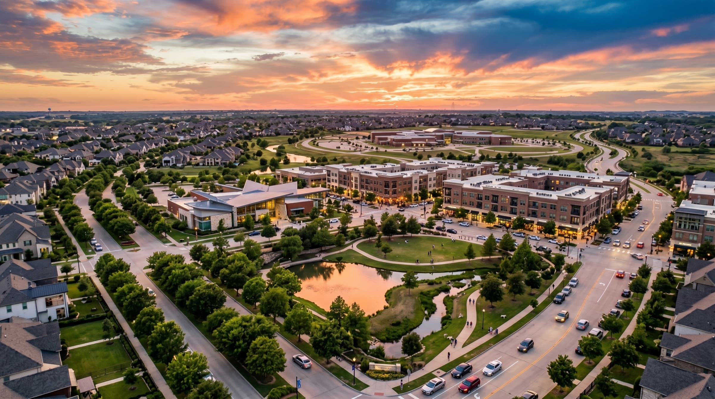 Aerial view of a North Texas town center at sunset, resembling Frisco